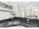 Granite countertops, a stainless steel sink, white cabinets, and a view of the living room at 4907 Ardenwoods Dr, Charlotte, NC 28215
