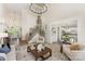 Open-concept living room with a grand staircase, adjacent kitchen, lots of natural light, and modern furnishings at 4907 Ardenwoods Dr, Charlotte, NC 28215