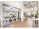 Bright living room with coffered ceilings, fireplace, hardwood floors and large windows providing natural light at 4907 Ardenwoods Dr, Charlotte, NC 28215