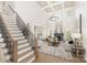 Bright living room with coffered ceilings, fireplace, hardwood floors and large windows providing natural light at 4907 Ardenwoods Dr, Charlotte, NC 28215