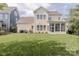 Wide backyard view, perfect for entertaining, featuring a sunroom and lush lawn at 5250 Meadowcroft Way, Fort Mill, SC 29708
