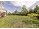Spacious backyard with lush green grass and mature trees, perfect for outdoor activities at 5250 Meadowcroft Way, Fort Mill, SC 29708