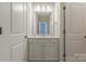 Bright bathroom featuring a white countertop, cabinet, and an open doorway at 5250 Meadowcroft Way, Fort Mill, SC 29708