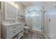 Elegant bathroom featuring a marble tiled shower, modern vanity, and updated fixtures at 5250 Meadowcroft Way, Fort Mill, SC 29708