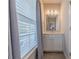 Bright bathroom features a granite countertop, white cabinets, and a curtain-covered window at 5250 Meadowcroft Way, Fort Mill, SC 29708