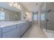 Elegant bathroom with dual sinks, granite countertops, and a glass-enclosed shower at 5250 Meadowcroft Way, Fort Mill, SC 29708