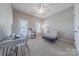 Well-lit room with neutral carpet, desk area, chair, and access to outdoor balcony at 5250 Meadowcroft Way, Fort Mill, SC 29708