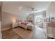 Cozy bedroom with neutral tones, decorative rug, ceiling fan, and ample natural light at 5250 Meadowcroft Way, Fort Mill, SC 29708