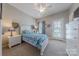 Cozy bedroom featuring white furniture, sports-themed décor, ceiling fan and lots of natural light at 5250 Meadowcroft Way, Fort Mill, SC 29708