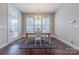 Bright dining room featuring hardwood floors, a rustic wood table, and a modern chandelier at 5250 Meadowcroft Way, Fort Mill, SC 29708
