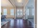 Spacious foyer featuring hardwood flooring, white trim, and double front doors at 5250 Meadowcroft Way, Fort Mill, SC 29708