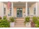Close up view of the front door and porch, with rocking chairs and decorations at 5250 Meadowcroft Way, Fort Mill, SC 29708
