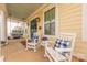 Cozy front porch with rocking chairs, swing, and charming decor elements at 5250 Meadowcroft Way, Fort Mill, SC 29708