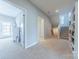 Spacious hallway with a staircase and built-in bookshelves, connecting different areas of the home at 5250 Meadowcroft Way, Fort Mill, SC 29708