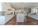 Open-concept kitchen with stainless appliances, a large island with seating, and seamless flow to the living area at 5250 Meadowcroft Way, Fort Mill, SC 29708