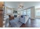 Bright living room with fireplace, large windows, hardwood floors, and comfortable seating arrangement at 5250 Meadowcroft Way, Fort Mill, SC 29708
