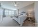 Serene main bedroom with large windows, a ceiling fan, and neutral decor at 5250 Meadowcroft Way, Fort Mill, SC 29708