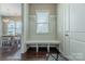 Welcoming mudroom with a built-in bench, hooks, and storage space near the home's entrance at 5250 Meadowcroft Way, Fort Mill, SC 29708