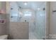 Contemporary shower featuring marble tiling, glass enclosure, and modern fixtures at 5250 Meadowcroft Way, Fort Mill, SC 29708