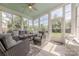 Relaxing sunroom with ample seating, large windows, and a view of the backyard at 5250 Meadowcroft Way, Fort Mill, SC 29708