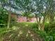 Brick home exterior with a concrete patio and stairs leading to a sliding glass door at 601 Scottsbrook Dr, Charlotte, NC 28213