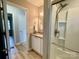 Renovated bathroom with granite counters, soft lighting, and glass shower door at 601 Scottsbrook Dr, Charlotte, NC 28213