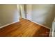 A cozy bedroom featuring hardwood floors and neutral-colored walls, creating a warm and inviting space at 601 Scottsbrook Dr, Charlotte, NC 28213
