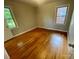 Bedroom with hardwood floors, two windows, and neutral color scheme at 601 Scottsbrook Dr, Charlotte, NC 28213