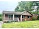 Charming single-story brick home featuring a cozy front porch and well-maintained lawn at 601 Scottsbrook Dr, Charlotte, NC 28213