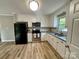 Spacious kitchen featuring granite countertops, stainless steel appliances, vinyl floors and updated white cabinets at 601 Scottsbrook Dr, Charlotte, NC 28213