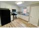 Well-lit kitchen with white cabinets, stainless steel appliances, and vinyl flooring at 601 Scottsbrook Dr, Charlotte, NC 28213