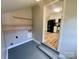 Laundry room featuring a view of a kitchen space, shelves, and access to exterior at 601 Scottsbrook Dr, Charlotte, NC 28213