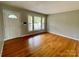 Bright living room showcasing hardwood floors, a large window, and neutral walls at 601 Scottsbrook Dr, Charlotte, NC 28213