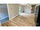Spacious living room with sliding glass doors, ceiling fan, and wood-look floors at 601 Scottsbrook Dr, Charlotte, NC 28213