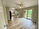 Spacious living room featuring modern floors, fan, and sliding glass doors leading to the outdoor area at 601 Scottsbrook Dr, Charlotte, NC 28213