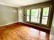 Bright living room with beautiful hardwood floors and a large window offering plenty of natural light at 601 Scottsbrook Dr, Charlotte, NC 28213