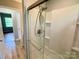 Shower with sliding glass door and an adjustable shower head at 601 Scottsbrook Dr, Charlotte, NC 28213