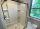 Close up of the Shower with glass doors and a mounted shower head at 601 Scottsbrook Dr, Charlotte, NC 28213