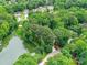 Aerial view showcasing the property's serene lakeside location, surrounded by lush greenery and neighboring homes at 6017 Lake Providence Ln, Charlotte, NC 28277