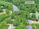 Aerial view of a home nestled in a lush, green landscape near the tranquil waters of Lake Providence at 6017 Lake Providence Ln, Charlotte, NC 28277