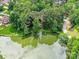 Aerial view of a lake surrounded by dense trees, showcasing the natural beauty of the property at 6017 Lake Providence Ln, Charlotte, NC 28277
