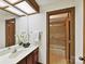 Bright bathroom with a mirrored wall, vanity and a view to the tiled shower in the bathroom at 6017 Lake Providence Ln, Charlotte, NC 28277