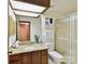 Well-lit bathroom featuring a skylight, shower stall, and granite vanity at 6017 Lake Providence Ln, Charlotte, NC 28277