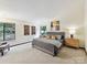 Spacious bedroom with large windows and comfortable furnishings offers a peaceful retreat at 6017 Lake Providence Ln, Charlotte, NC 28277