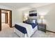 Comfortable bedroom with blue accents, plush carpet, and neutral wall color at 6017 Lake Providence Ln, Charlotte, NC 28277