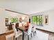 Bright dining room with a modern table setting, large windows, and views of the surrounding greenery at 6017 Lake Providence Ln, Charlotte, NC 28277
