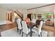Spacious dining area with a wooden table, white chairs, and open access to the living room and foyer at 6017 Lake Providence Ln, Charlotte, NC 28277
