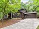 Charming home with a stone facade and a well-maintained lawn, complemented by a paved driveway at 6017 Lake Providence Ln, Charlotte, NC 28277