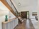 Elegant foyer with a wooden staircase, brick flooring, and modern lighting, creating a welcoming atmosphere at 6017 Lake Providence Ln, Charlotte, NC 28277
