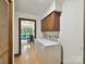 Efficient laundry room with cabinets and view to a bright office space at 6017 Lake Providence Ln, Charlotte, NC 28277